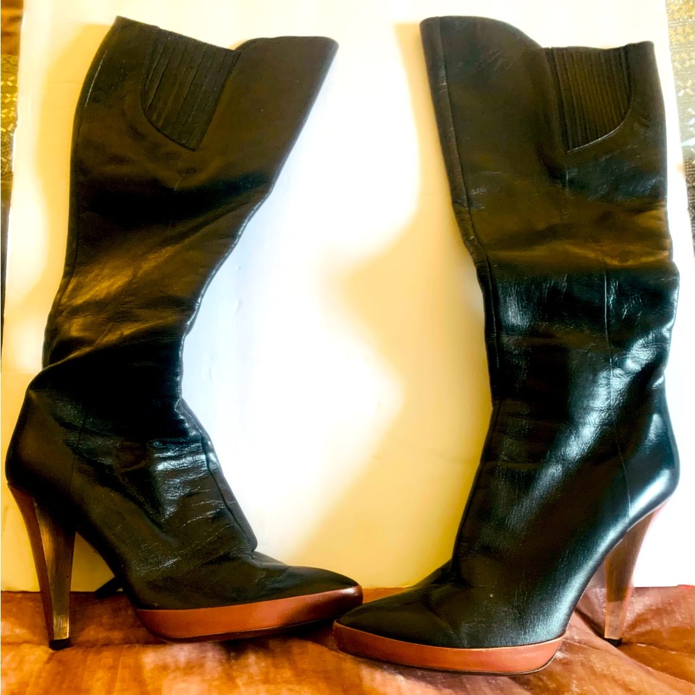 Mui Mui women’s black knee high leather boots.